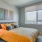 1 Bedroom Apartments in Oakland, CA - Caspian - Furnished Bedroom with Wood-Style Flooring and a Large Window with City Views