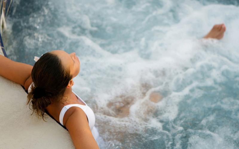 a woman relaxing in a hot tub